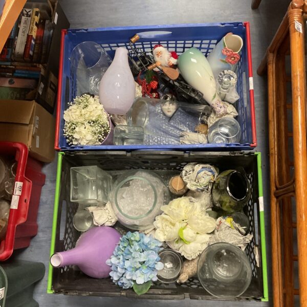 Mixed lot of glass vases and floral decorations for home decor.