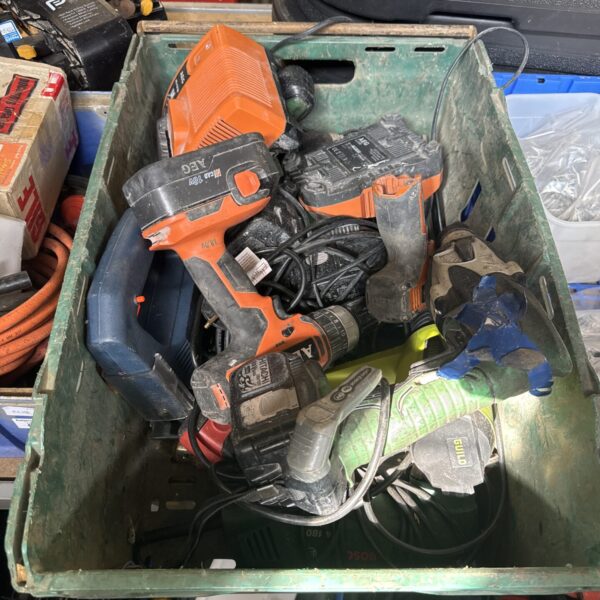 Assorted AEG cordless power tools in a tray, including a drill and impact driver.