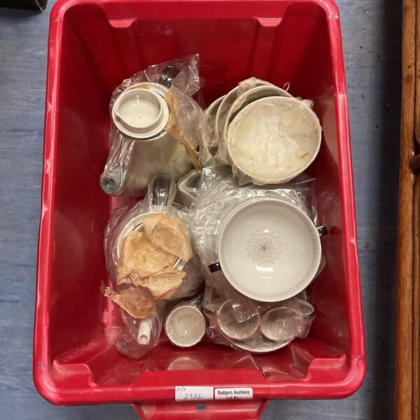 Vintage china collection with teapots, bowls, and cups in a box.