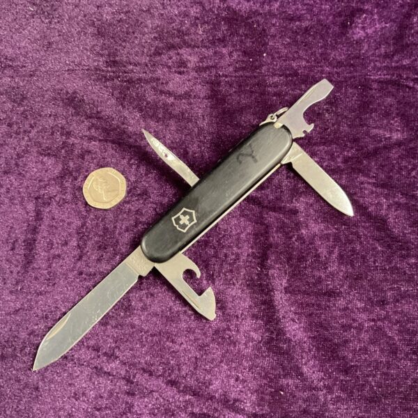 Vintage Victorinox Swiss Army Knife with red handle and tools.