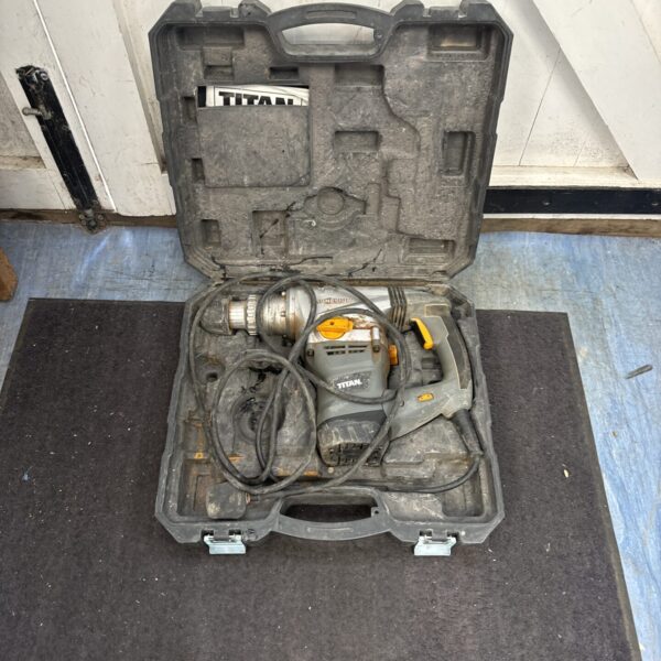 Large Titan hammer drill in its original carrying case, spares or repair.