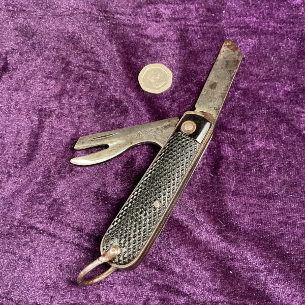 Vintage 1943 British military pocket knife, showing wear.