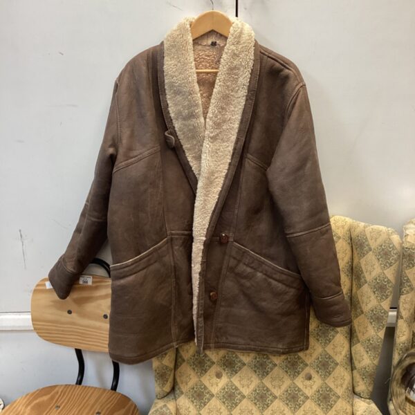 Vintage brown leather jacket with fleece lining and shearling collar.