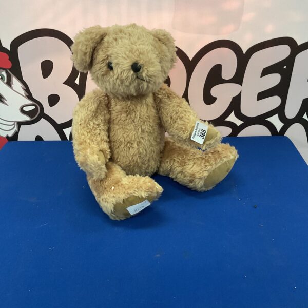 Vintage golden teddy bear, antique plush toy for collectors.