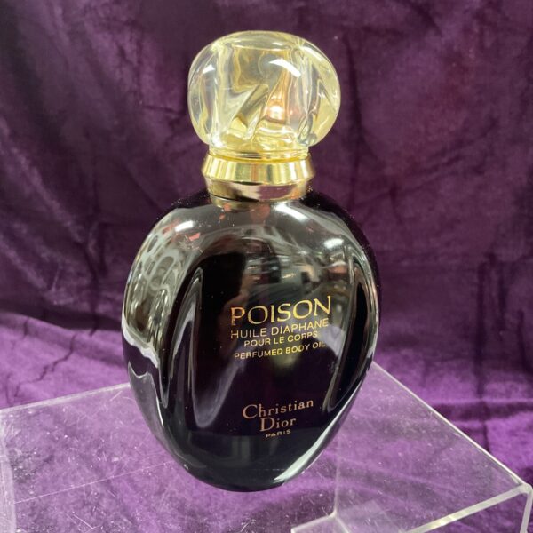 Vintage Christian Dior Poison perfumed body oil in black bottle.