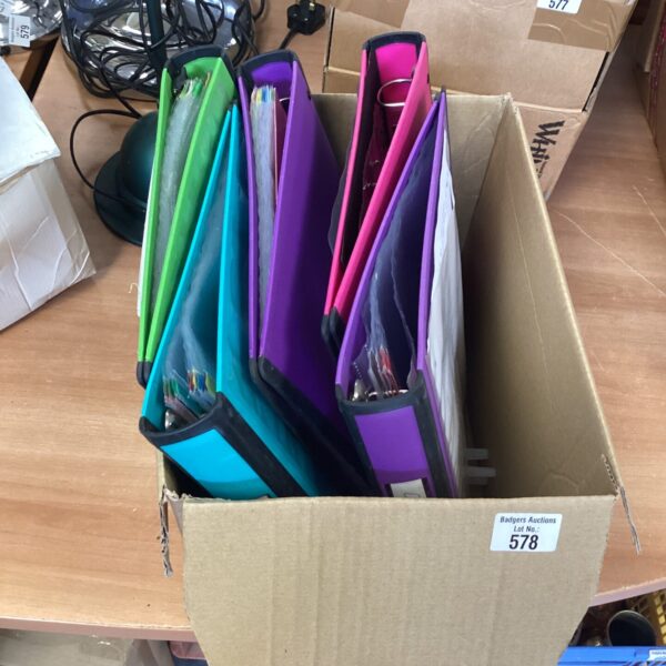 Assorted colour A4 ring binders for document organisation.