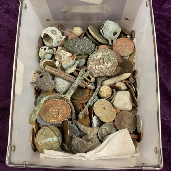 Tray of metal detector finds including coins and buttons.
