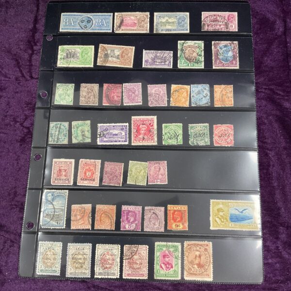 Vintage Ceylon and Indian postage stamps on a page for collectors.