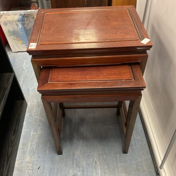 Vintage mahogany nest of tables, showcasing warm wood tones.