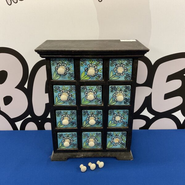 Colourful Indian pottery drawer chest with small drawers.