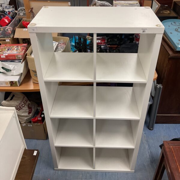 White Ikea shelving unit for storage and display.