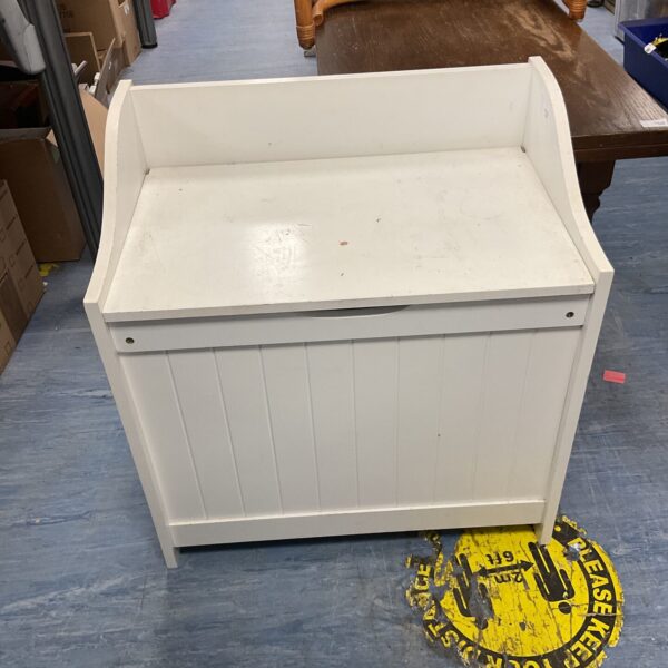 Wooden storage hamper for laundry and linens.