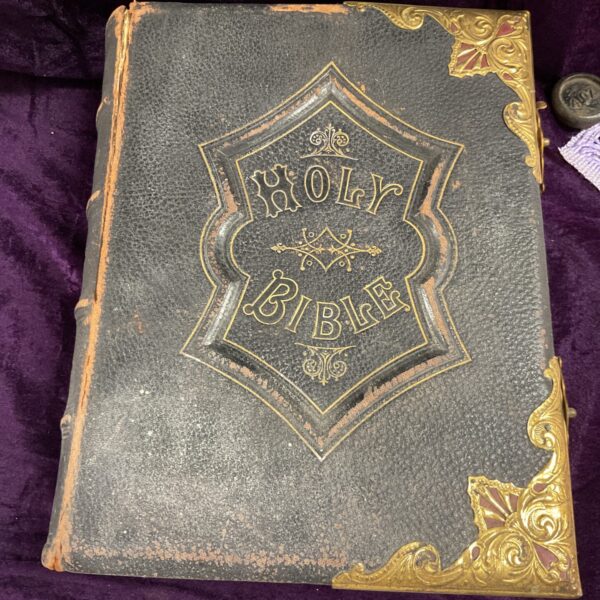 Antique Holy Bible with embossed leather cover and gilt details.