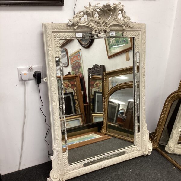 Ornate 19th-century French carved wood mirror with floral details.