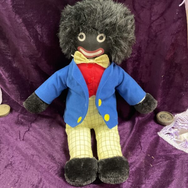 Large vintage golly doll with blue jacket and yellow trousers.