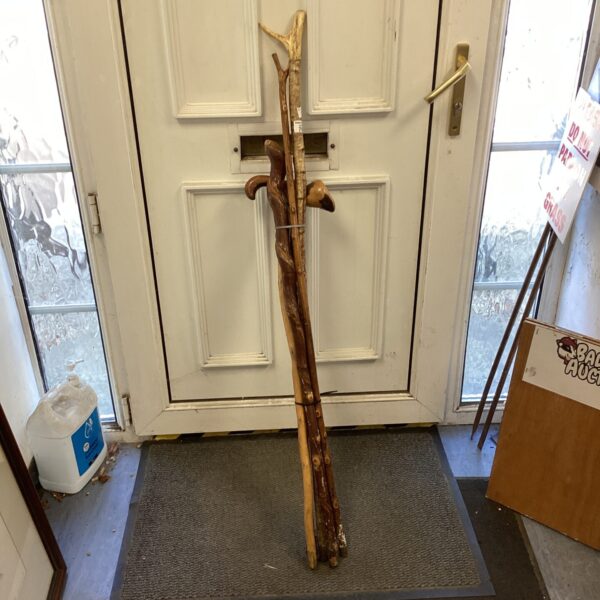 Selection of vintage walking sticks for hiking or display.