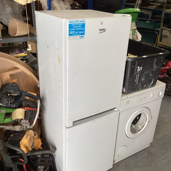 Used Beko tall fridge freezer in a cluttered environment.
