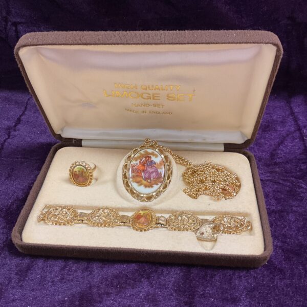 Vintage Limoges jewellery set with delicate floral porcelain details.
