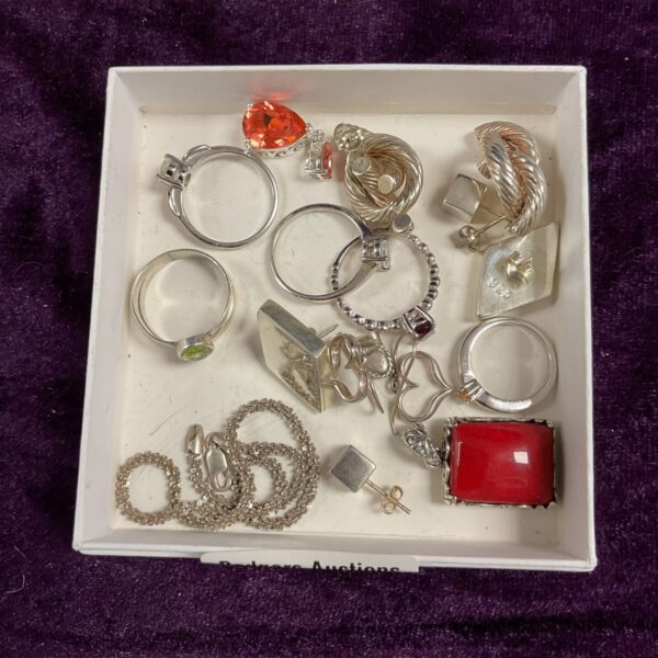 Mixed lot of silver and costume jewellery rings and pendants.