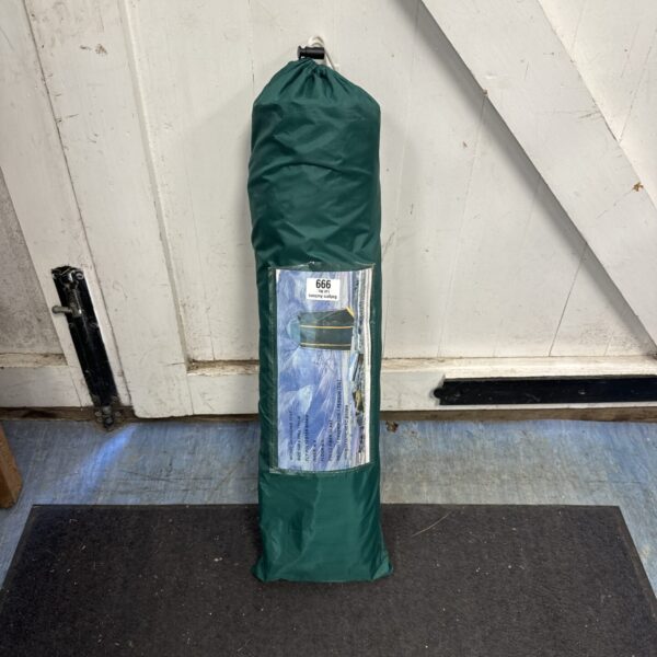 Green camping changing tent folded in carry bag.
