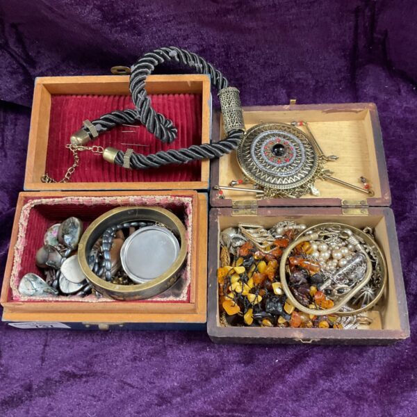 Two jewellery boxes filled with assorted costume jewellery and trinkets.