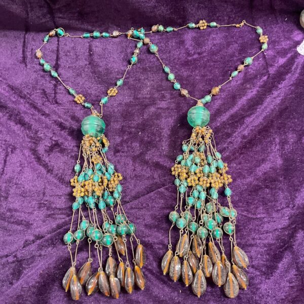 Vintage teal and amber glass bead necklaces with cascading design.