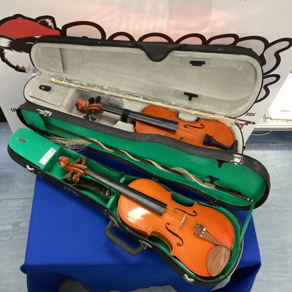 Two cased violins presented in a vintage set.