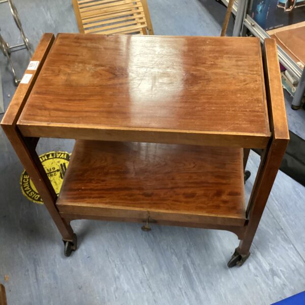 Antique walnut butler table with folding top and castors.