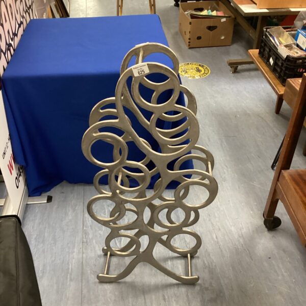 Metal Libra wine rack holding twelve bottles.