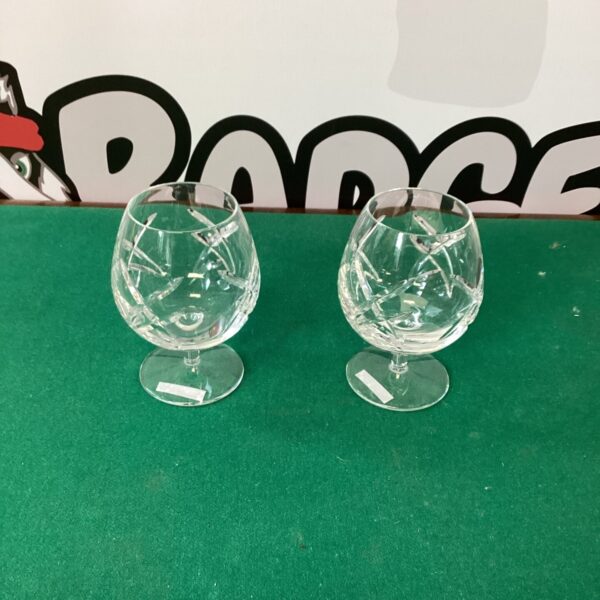 Pair of Waterford Galway cut crystal brandy glasses on display.