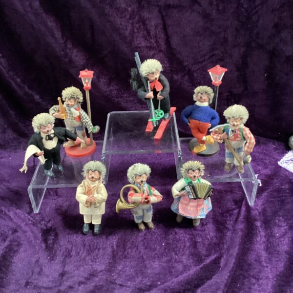 Vintage Mecki figures collection, GDR character toys displayed on purple.