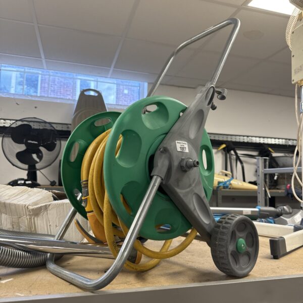 Hozelok garden hose reel with green hose wound on it.