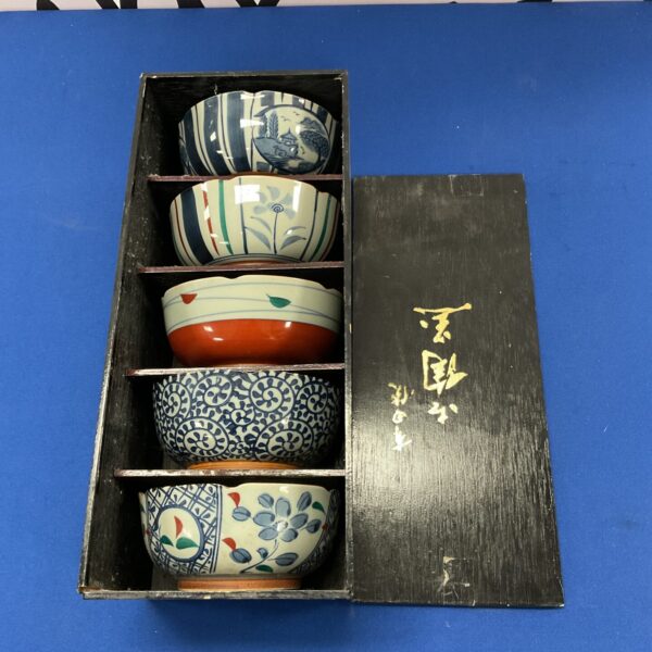 Set of six vintage Chinese rice bowls with blue floral design.