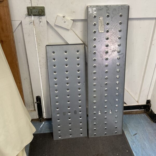 Two metal scaffolding plates for construction and industrial use.