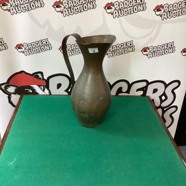 Large handmade copper jug with aged patina.