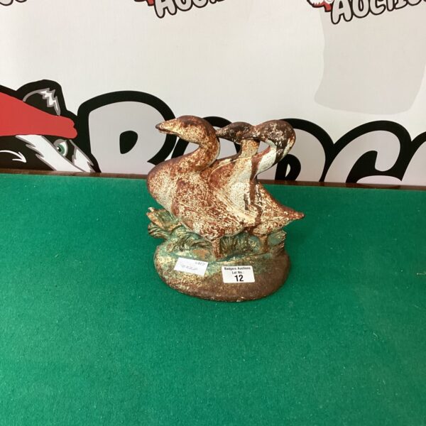 Vintage metal goose door stop for farmhouse decor.