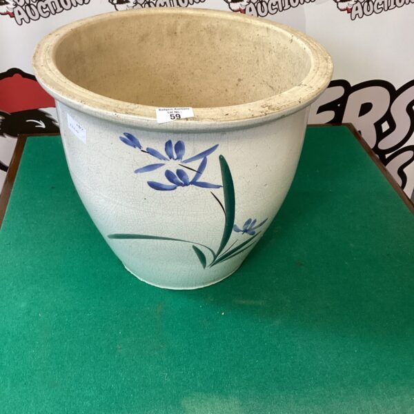 Large earthenware garden pot with blue floral design for outdoor plants.