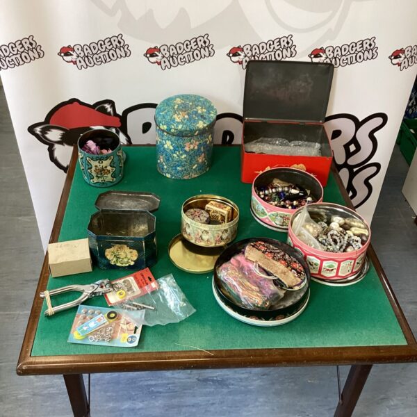 Vintage tin selection lot with mixed contents and decorative designs.