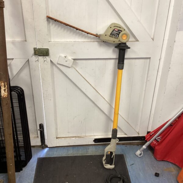 Ryobi pole hedge cutter for trimming tall hedges and shrubs.