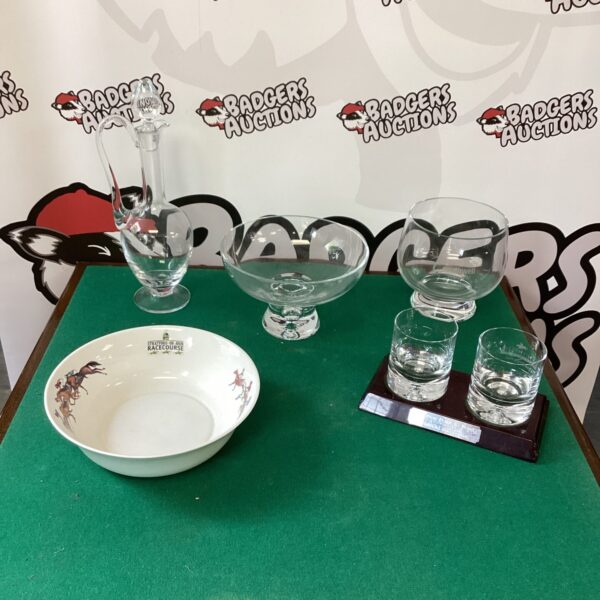 Vintage horse racing trophies in glass and porcelain on display.