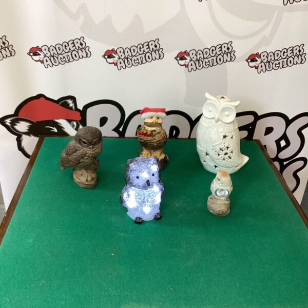 Selection of colourful ceramic garden owl ornaments for outdoor display.