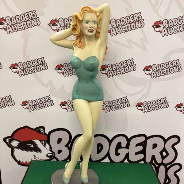Vintage 1950s pinup girl statue for collectors and retro decor.