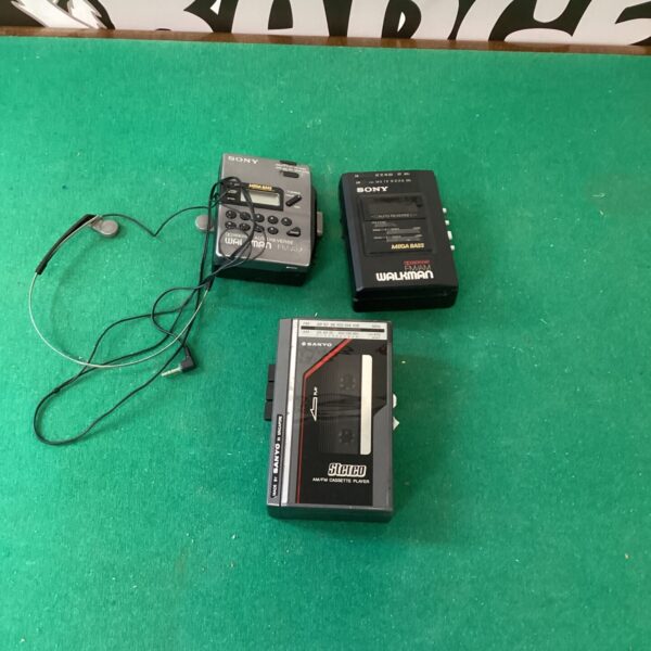 Vintage Sony Walkman and Sanyo cassette players, retro audio equipment.