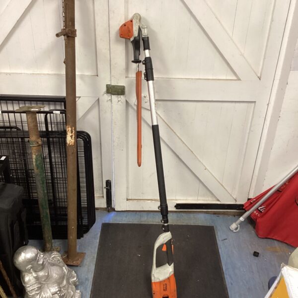 Used Stihl cordless pole hedge trimmer for garden maintenance.
