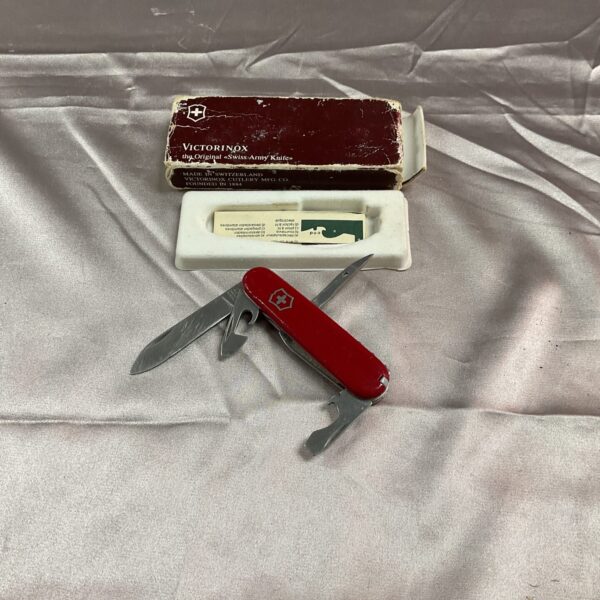 Vintage red handled Victorinox Swiss Army Knife, a classic multi-tool.