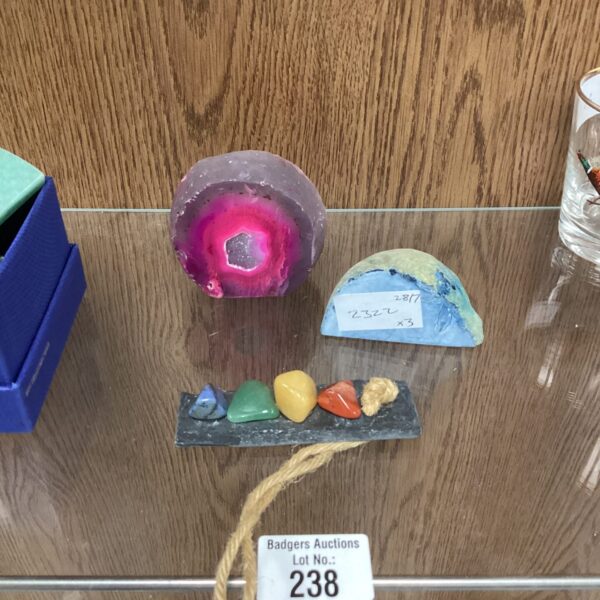 Polished pink agate end with assorted colourful stones on display.