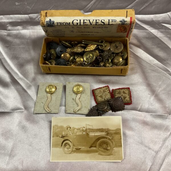 Vintage military buttons, badges, and cloth insignia collection.