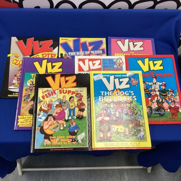 A stack of vintage Viz annuals and one Garfield annual.