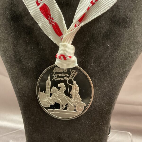 Front view of the Mars London 87 marathon medal with chariot design.