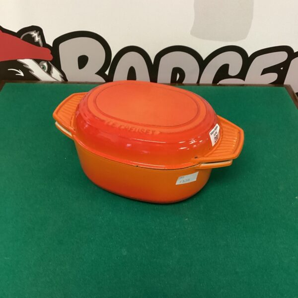 Vibrant orange Le Creuset roasting pot, vintage enameled cast iron.